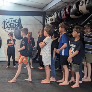 Mini Assassins learning martial arts respect and traditional Thai boxing values.